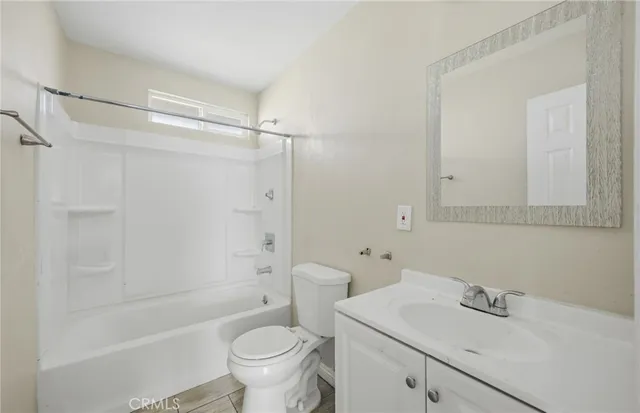 a bathroom with a sink mirror toilet and bathtub