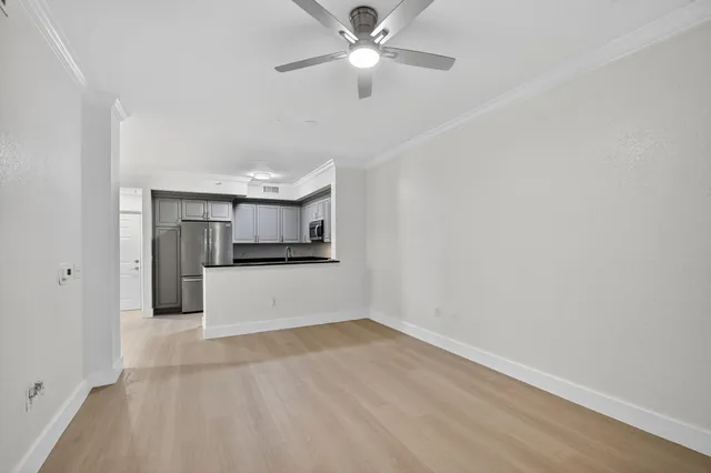 a bathroom with a granite countertop sink a toilet and a mirror
