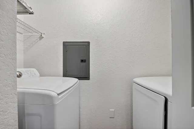 a view of a building with a yard and sitting area