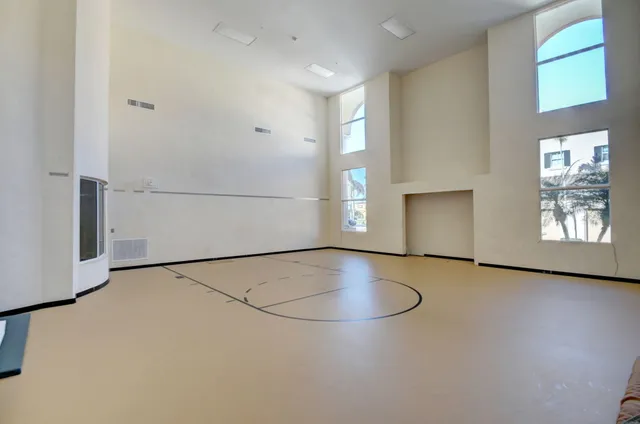 a living room with furniture a flat screen tv and a dining table