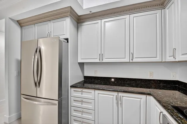 a kitchen with granite countertop a sink and cabinets