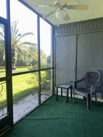 a view of a porch with chairs and backyard