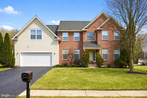 a view of a living room with furniture and wooden floor