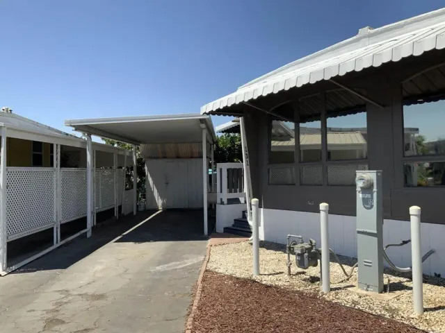 a backyard of a house with table and chairs