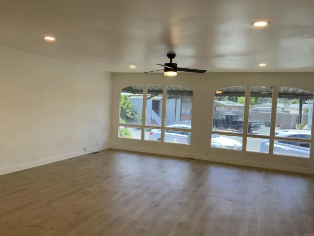 a kitchen with stainless steel appliances granite countertop a stove a sink dishwasher a refrigerator and a microwave