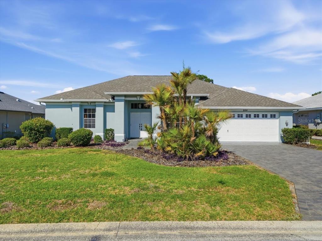 9311 Butler Boulevard Weeki Wachee, FL 34613 - Photo 15 of 60 a front view of a house with a yard