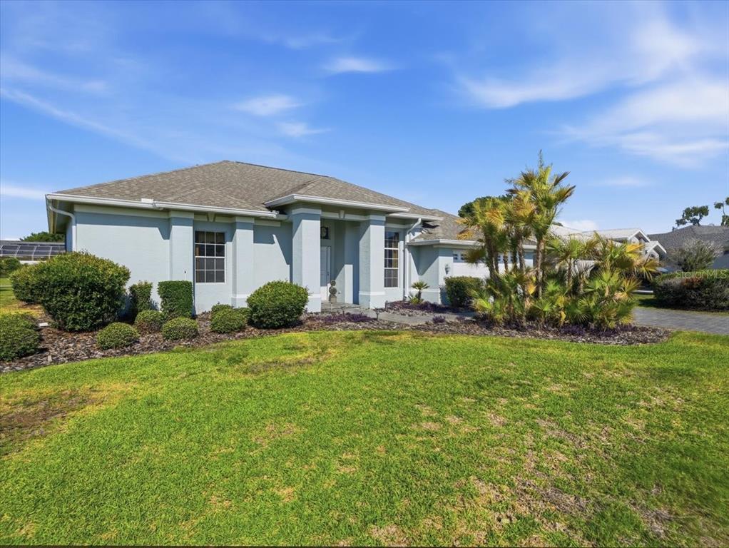 9311 Butler Boulevard Weeki Wachee, FL 34613 - Photo 17 of 60 a front view of a house with a yard
