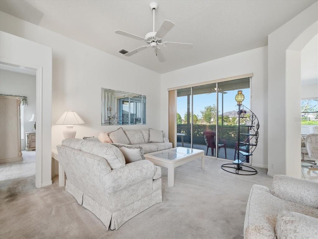 9311 Butler Boulevard Weeki Wachee, FL 34613 - Photo 20 of 60 a living room with furniture and a large window