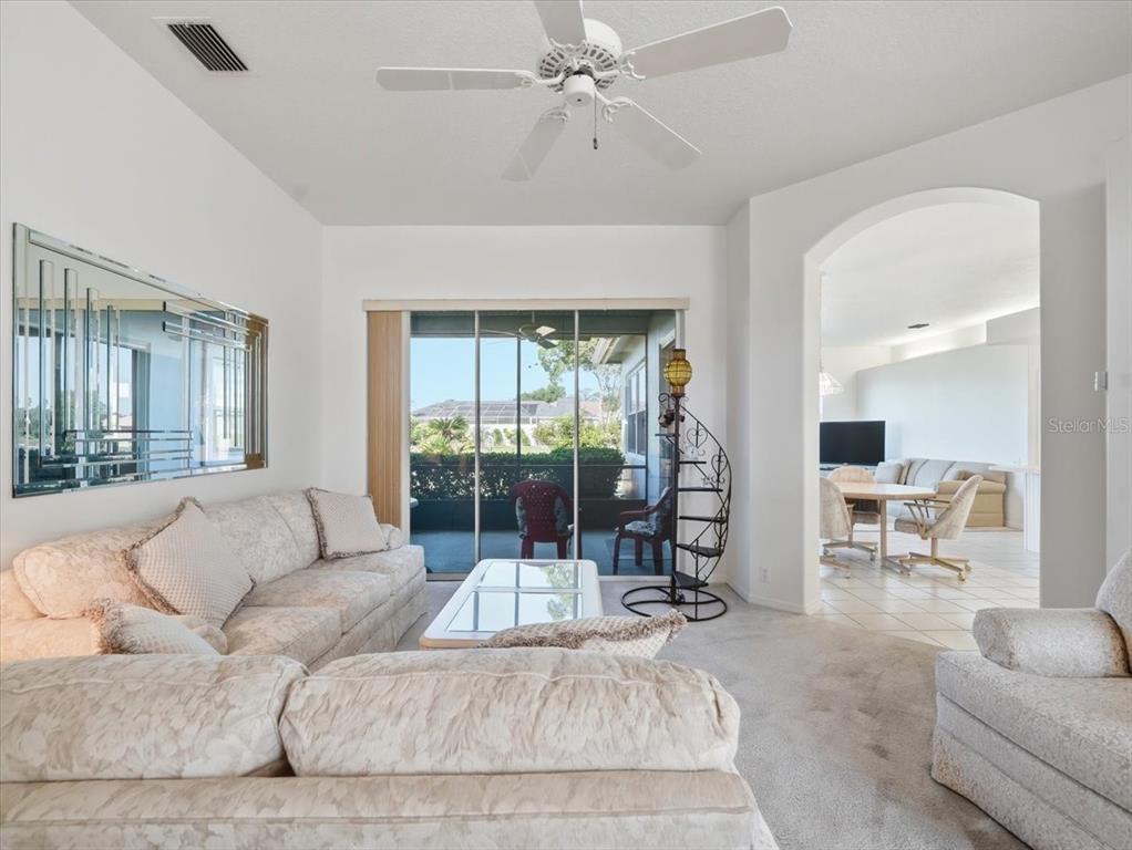 9311 Butler Boulevard Weeki Wachee, FL 34613 - Photo 21 of 60 a living room with furniture and a large window