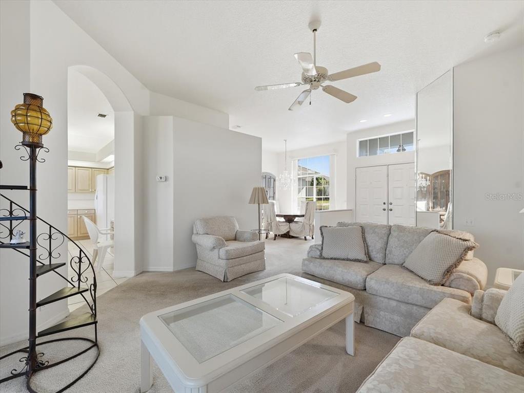 9311 Butler Boulevard Weeki Wachee, FL 34613 - Photo 23 of 60 a living room with furniture and a ceiling fan