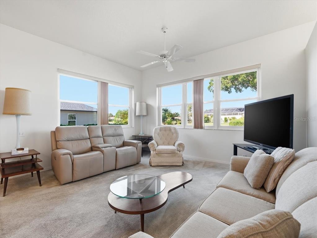 9311 Butler Boulevard Weeki Wachee, FL 34613 - Photo 26 of 60 a living room with furniture and a flat screen tv