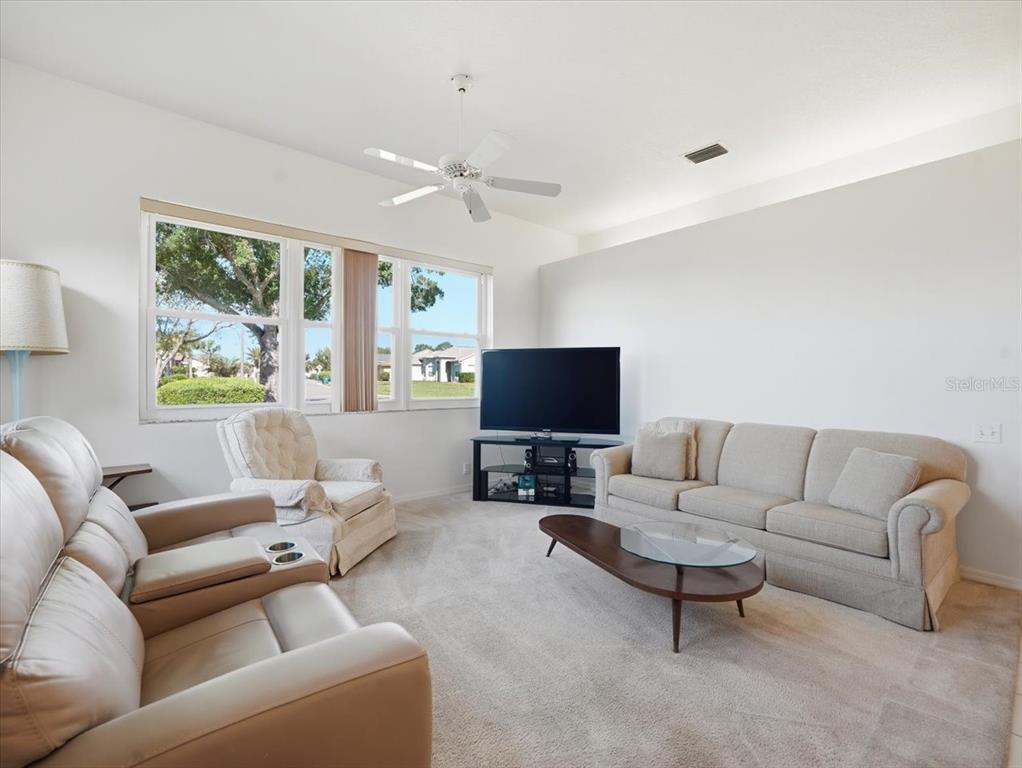 9311 Butler Boulevard Weeki Wachee, FL 34613 - Photo 27 of 60 a living room with furniture and a flat screen tv