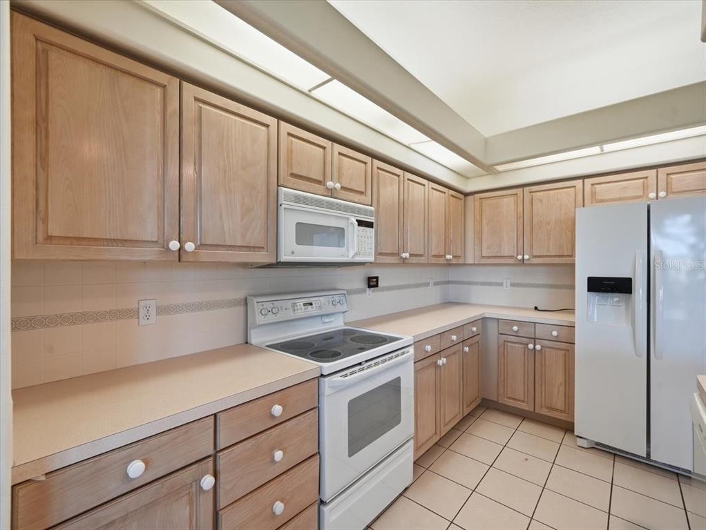 9311 Butler Boulevard Weeki Wachee, FL 34613 - Photo 37 of 60 a kitchen with a stove sink and cabinets