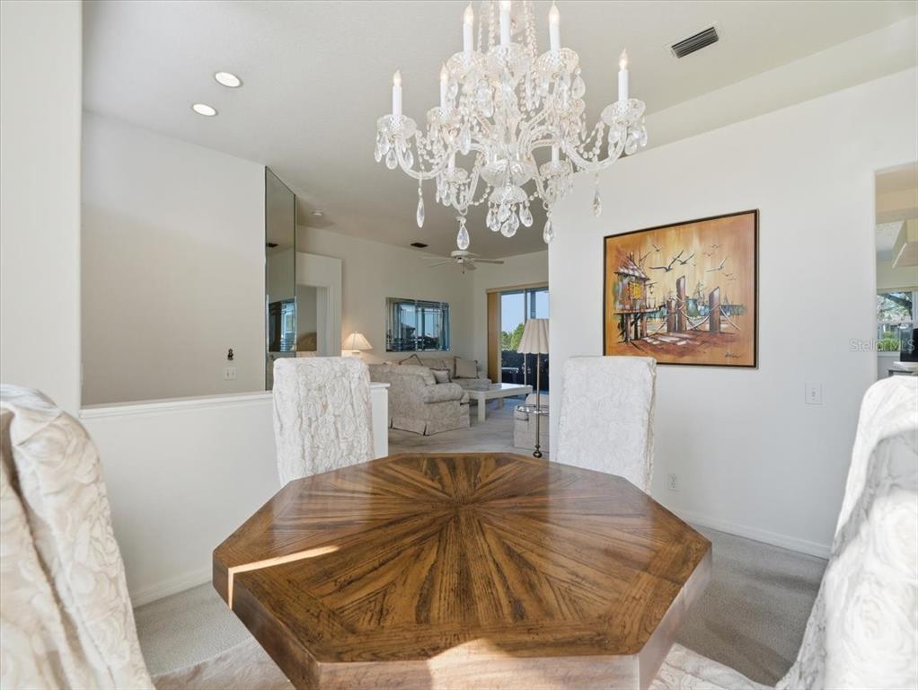 9311 Butler Boulevard Weeki Wachee, FL 34613 - Photo 40 of 60 a living room with furniture and a chandelier