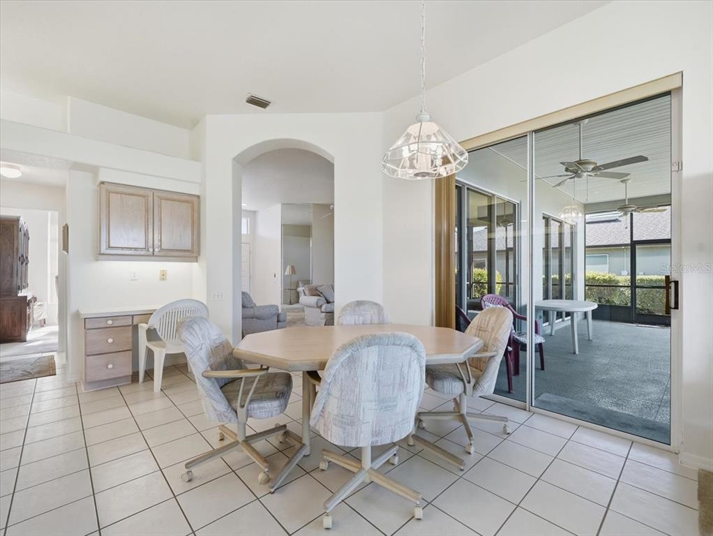 9311 Butler Boulevard Weeki Wachee, FL 34613 - Photo 42 of 60 a dining room with furniture a chandelier and window