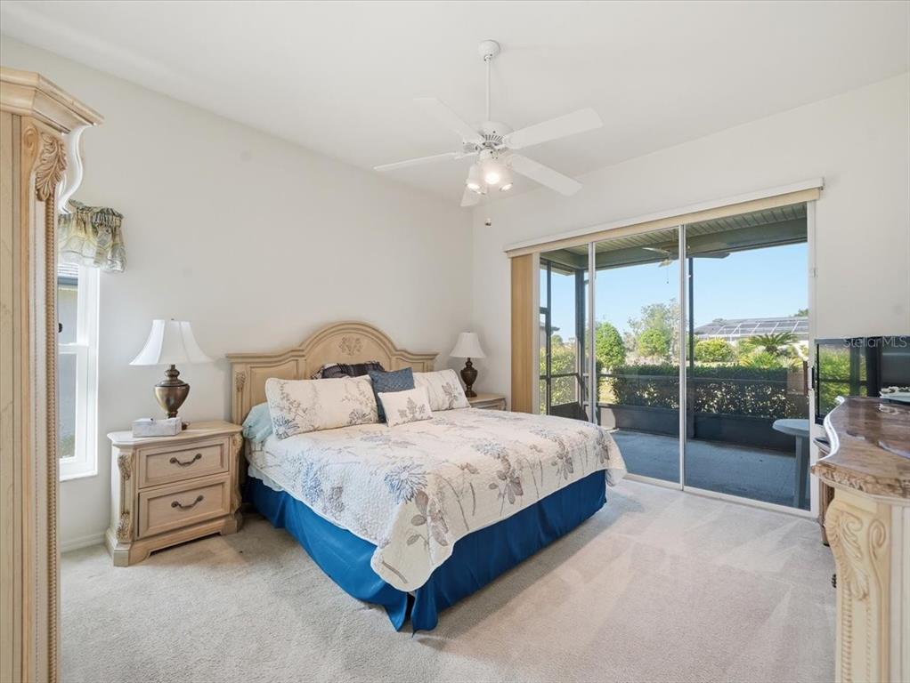 9311 Butler Boulevard Weeki Wachee, FL 34613 - Photo 43 of 60 a bedroom with a large bed and a chandelier