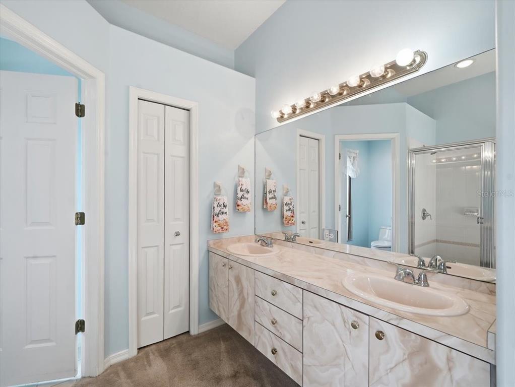 9311 Butler Boulevard Weeki Wachee, FL 34613 - Photo 47 of 60 a bathroom with double sink and a mirror