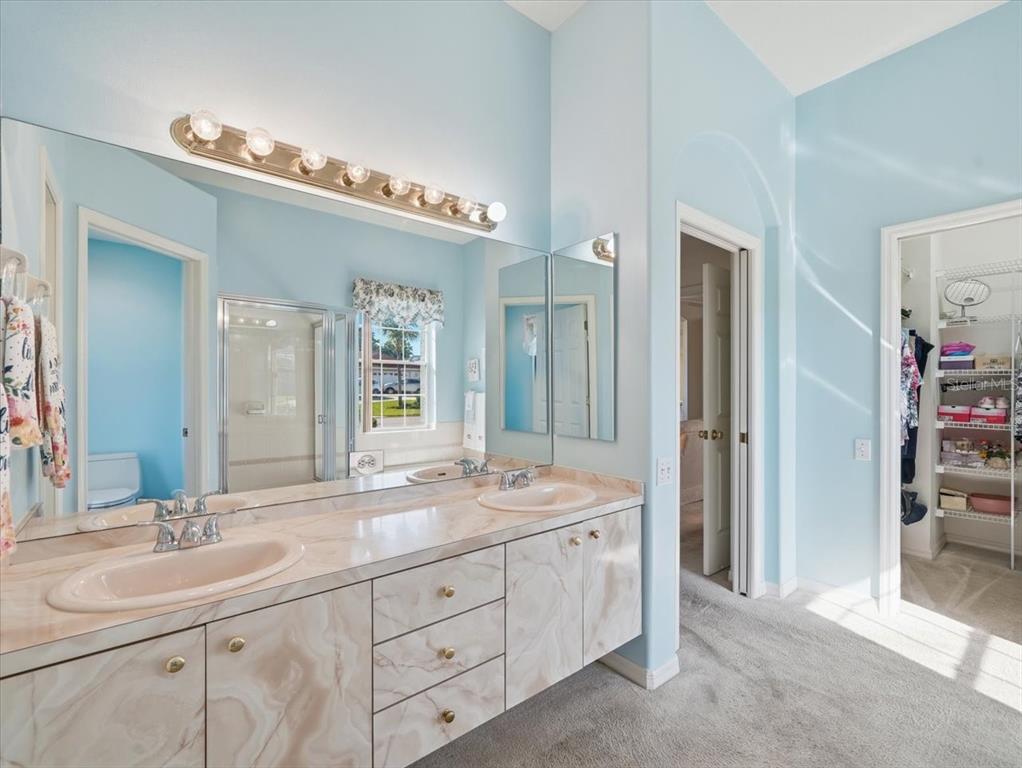 9311 Butler Boulevard Weeki Wachee, FL 34613 - Photo 48 of 60 a spacious bathroom with a double vanity sink mirror and double