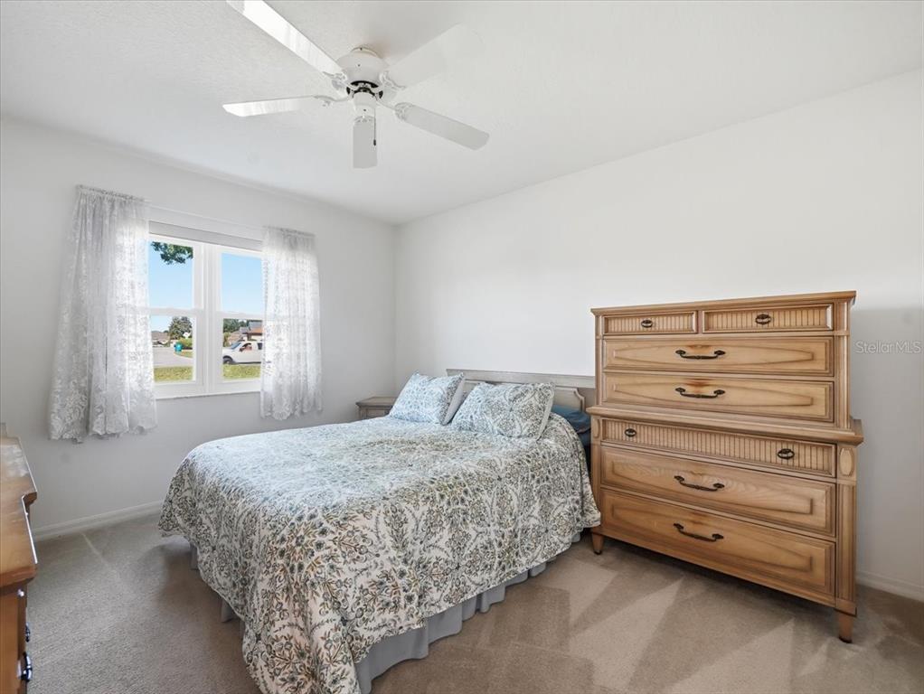 9311 Butler Boulevard Weeki Wachee, FL 34613 - Photo 50 of 60 a bedroom with a bed and a dresser