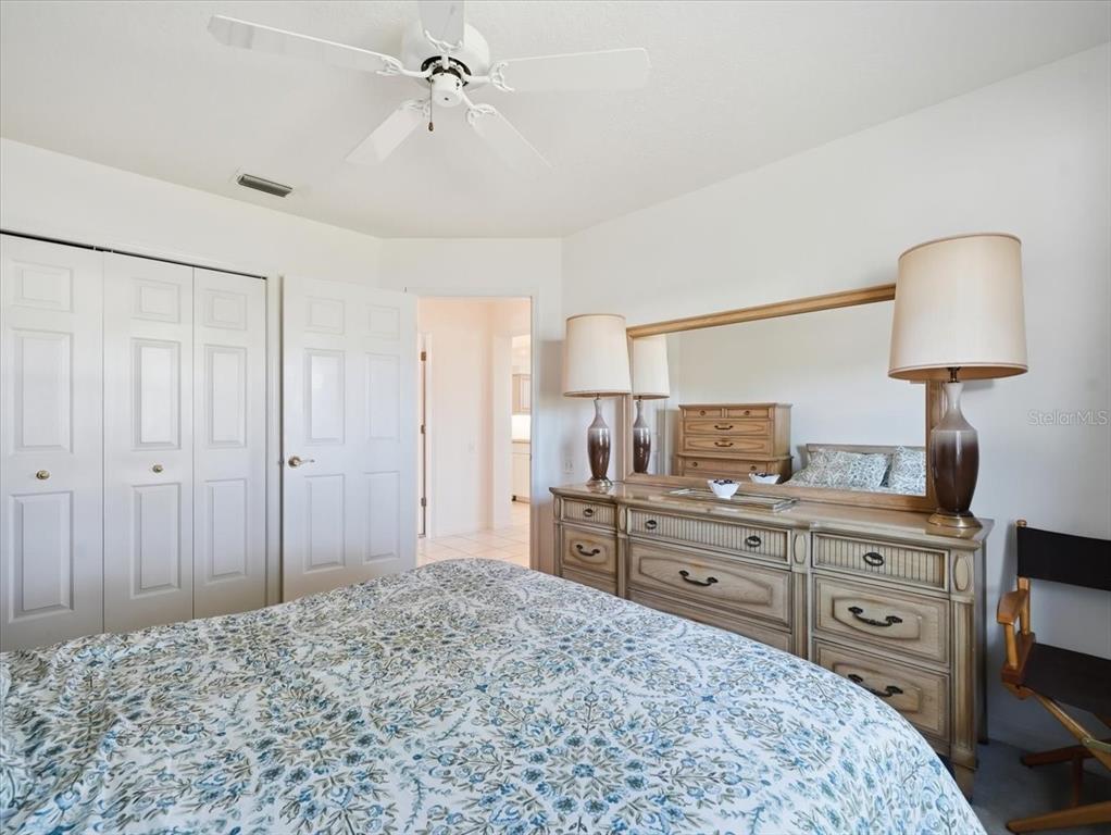 9311 Butler Boulevard Weeki Wachee, FL 34613 - Photo 51 of 60 a bedroom with a bed and a dresser