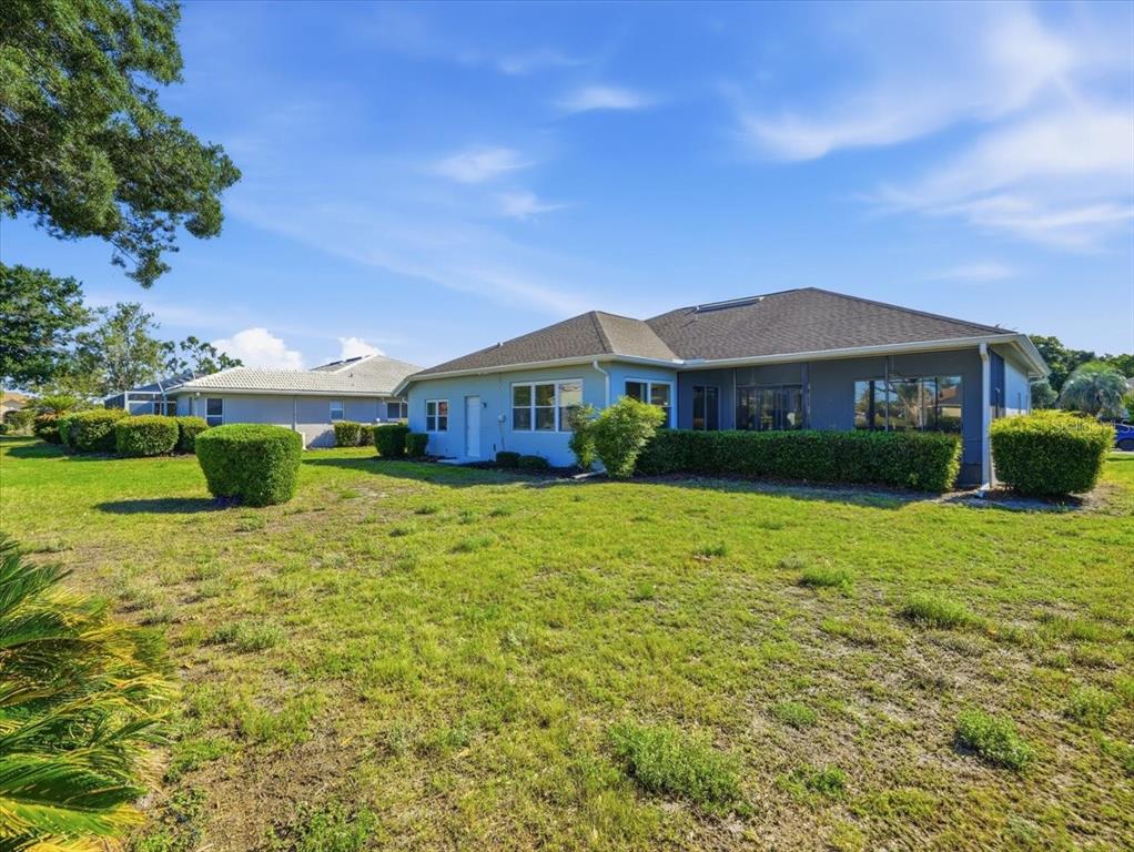 9311 Butler Boulevard Weeki Wachee, FL 34613 - Photo 60 of 60 a front view of a house with a garden