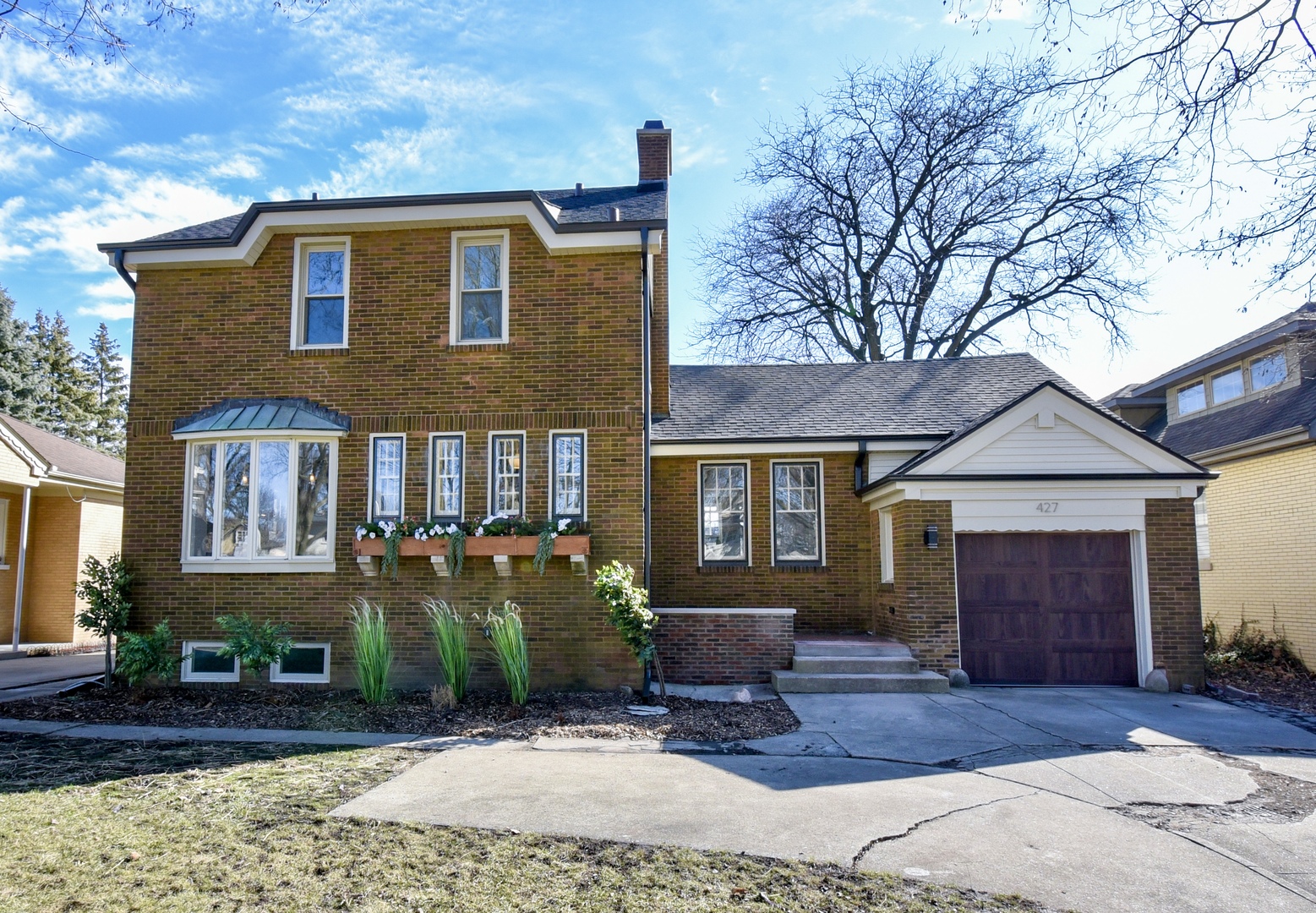 427 Uvedale Road Riverside, IL 60546 - Photo 1 of 33 a front view of a house with garden