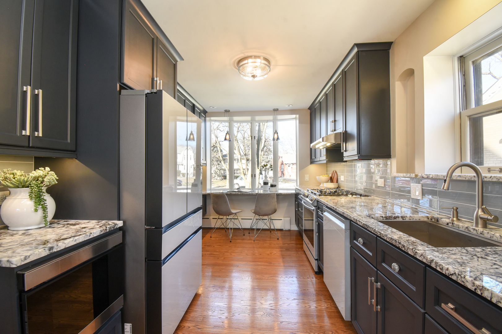 427 Uvedale Road Riverside, IL 60546 - Photo 9 of 33 a large kitchen with granite countertop a lot of counter space and a sink