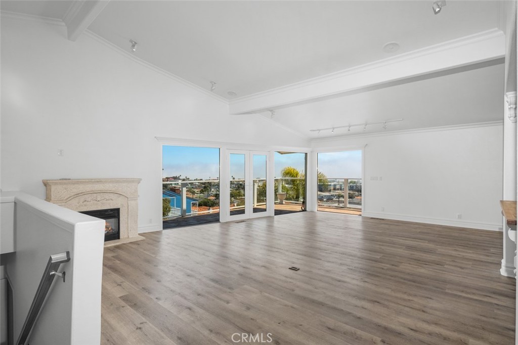 33941 Granada Drive Dana Point, CA 92629 - Photo 15 of 61 wooden floor fireplace and windows in an empty room