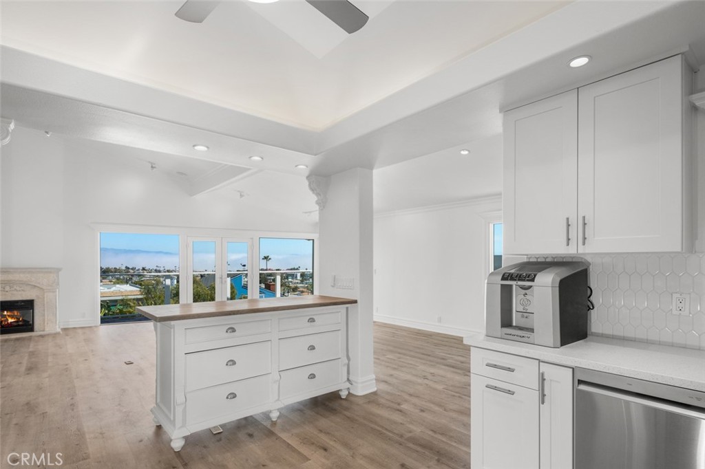 33941 Granada Drive Dana Point, CA 92629 - Photo 16 of 61 a kitchen with white cabinets and appliances
