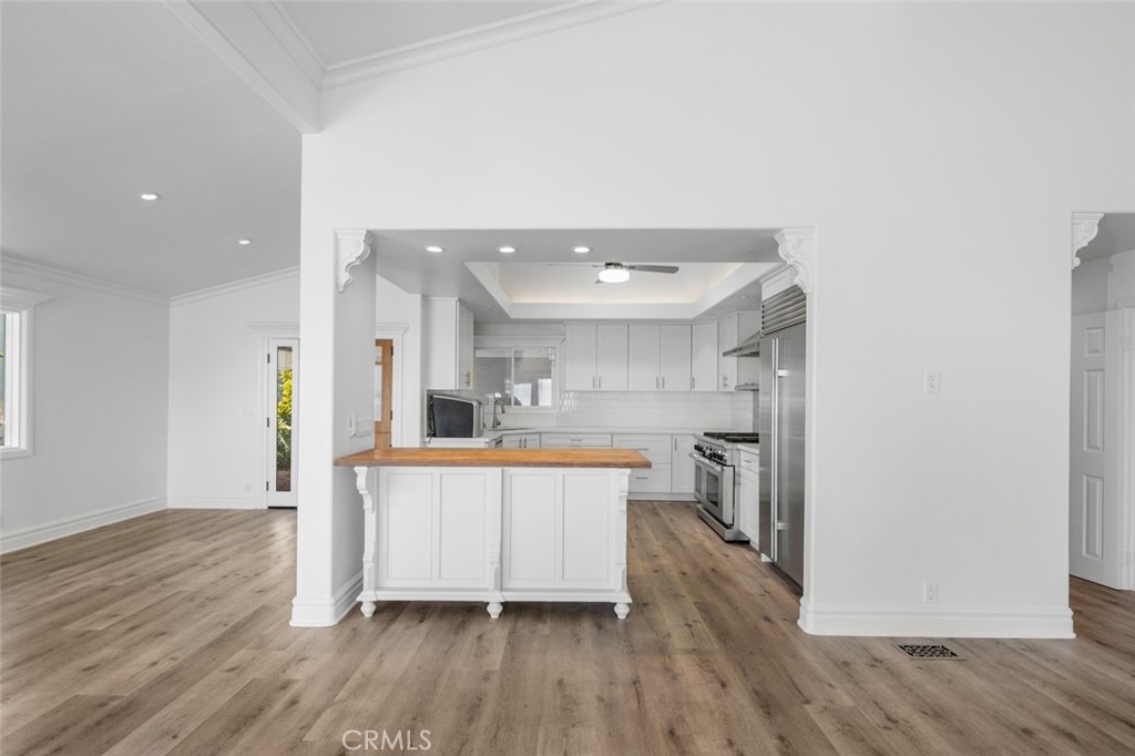 33941 Granada Drive Dana Point, CA 92629 - Photo 19 of 61 a large kitchen with a wooden floor and stainless steel appliances