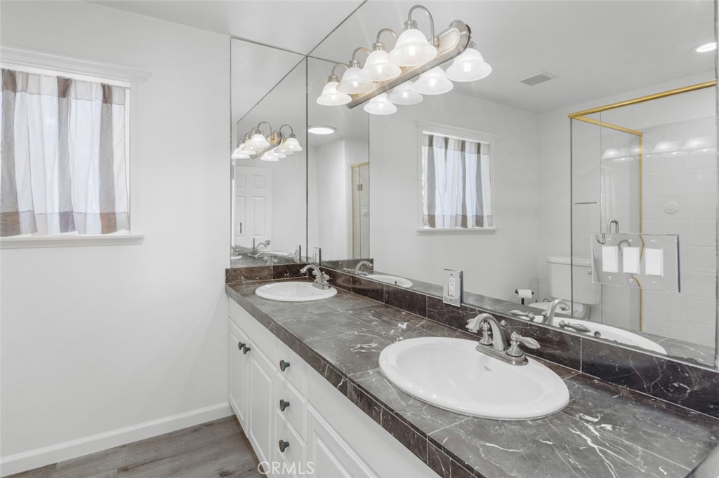 33941 Granada Drive Dana Point, CA 92629 - Photo 24 of 61 a bathroom with a granite countertop sink a large mirror and vanity
