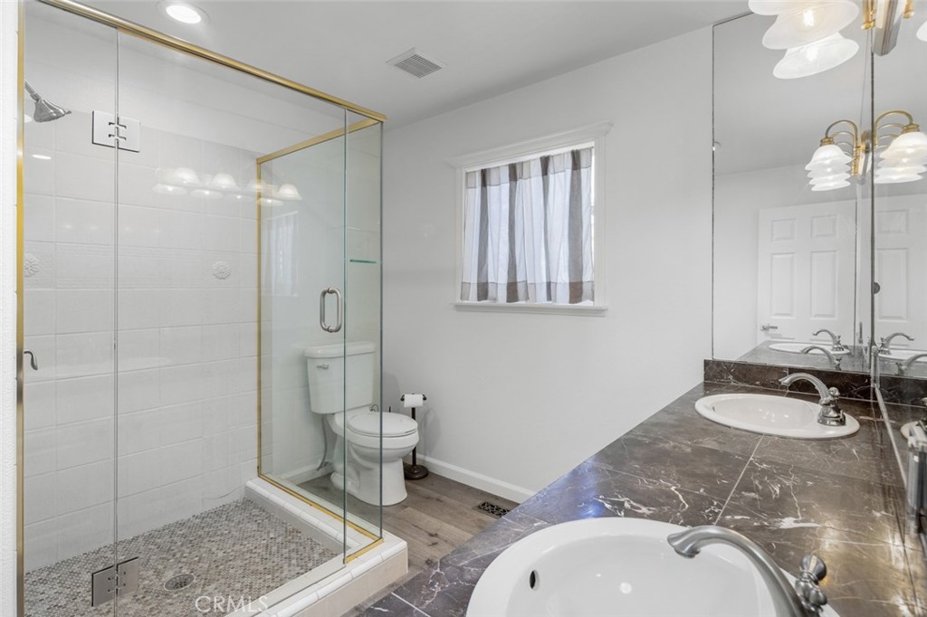 33941 Granada Drive Dana Point, CA 92629 - Photo 26 of 61 a bathroom with a sink a toilet and shower