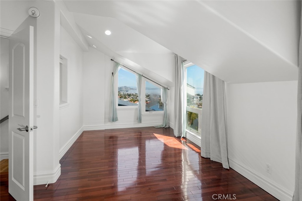 33941 Granada Drive Dana Point, CA 92629 - Photo 31 of 61 a view of a hallway with wooden floor and a kitchen