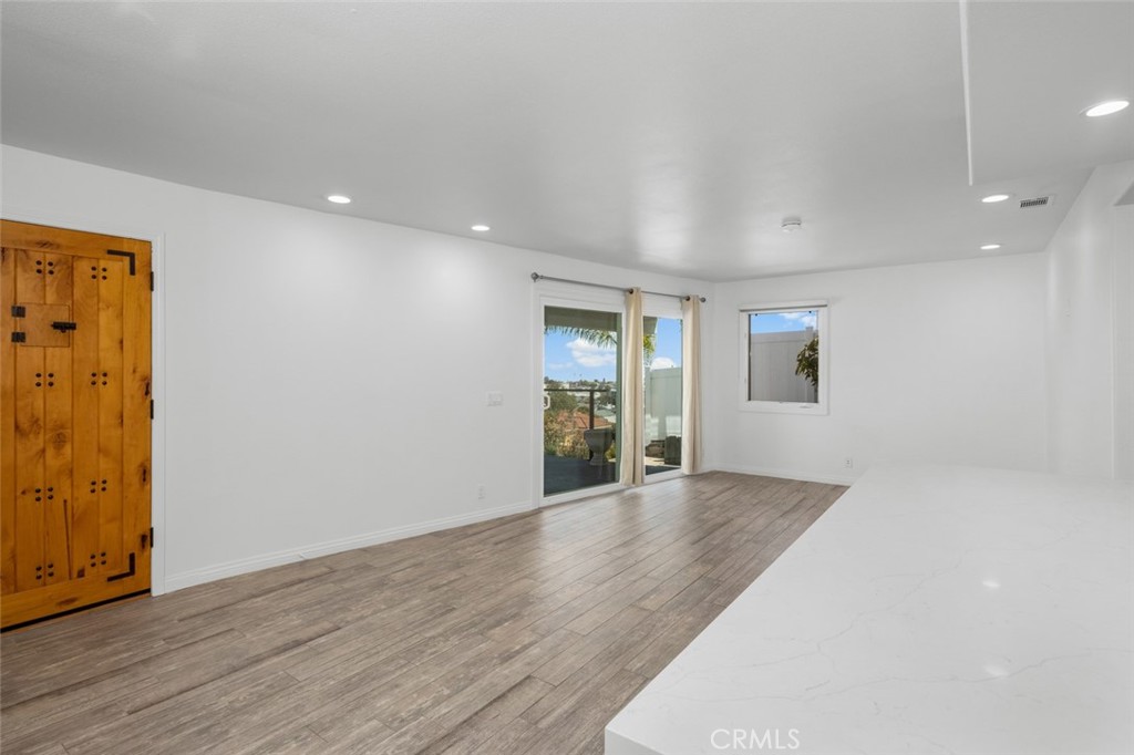 33941 Granada Drive Dana Point, CA 92629 - Photo 40 of 61 an empty room with wooden floor and windows