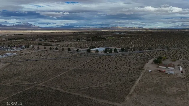 a view of a dry yard with wooden floor and city view