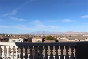 207 Priority Point Street Henderson, NV 89012 - Photo 16 of 23 Panoramic mountain and valley vistas stretch out beyond the elegant balcony railing.