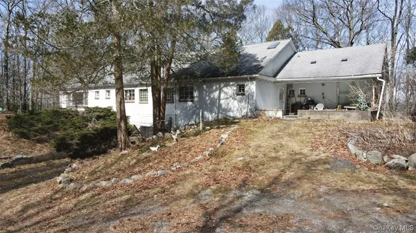 a view of a house with a large tree
