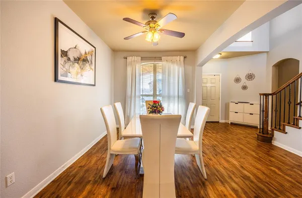 a view of a dining room with furniture a chandelier and wooden floor
