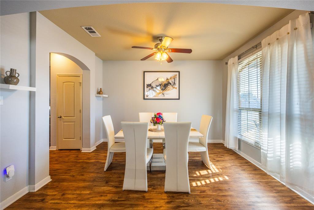 10864 Aurora Drive Waco, TX 76708 - Photo 15 of 40 a view of a dining room with furniture a chandelier and wooden floor