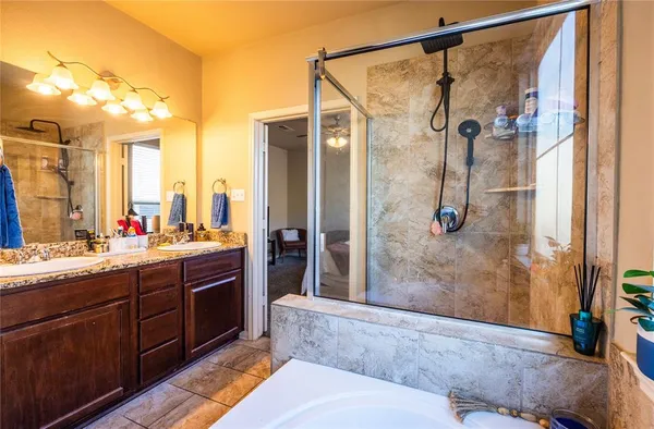 a bathroom with a tub sink and mirror