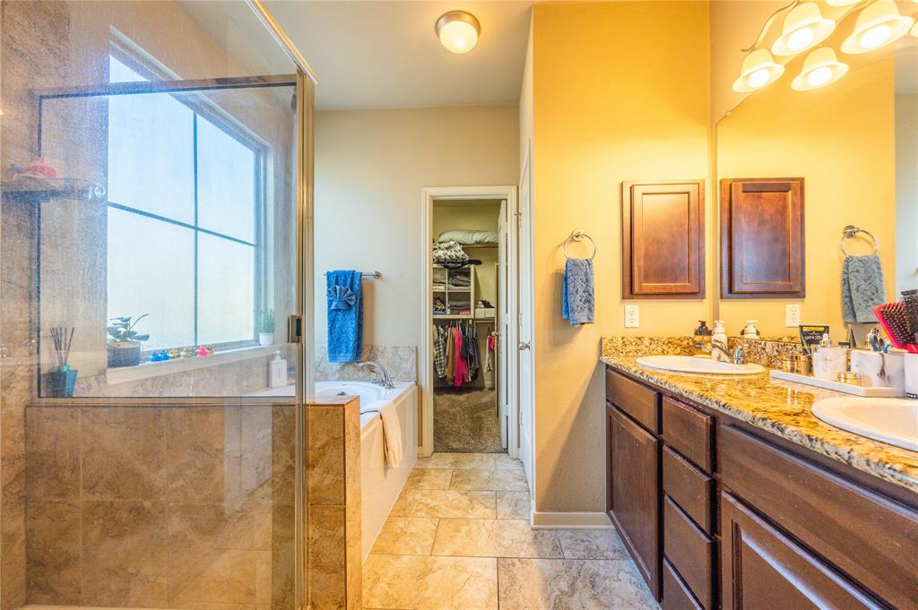 10864 Aurora Drive Waco, TX 76708 - Photo 20 of 40 a bathroom with a tub sink and mirror