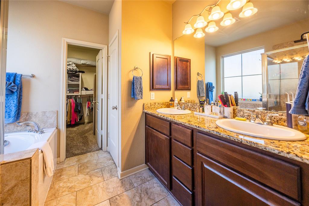 10864 Aurora Drive Waco, TX 76708 - Photo 26 of 40 a bathroom with a sink double vanity and a mirror