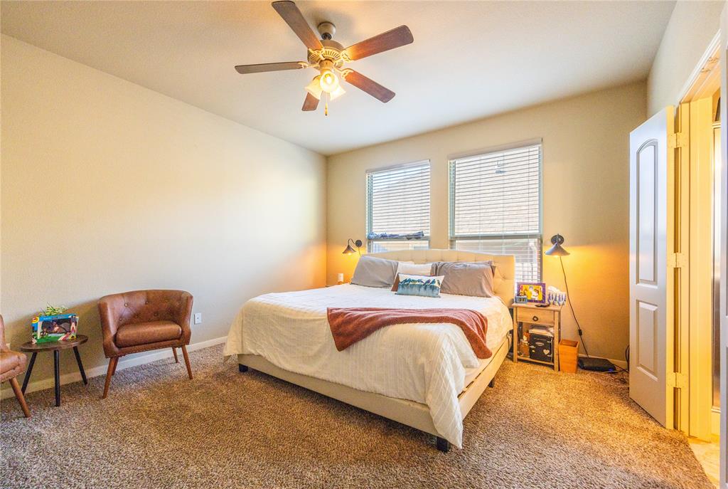 10864 Aurora Drive Waco, TX 76708 - Photo 27 of 40 a bed room with a bed and a chandelier