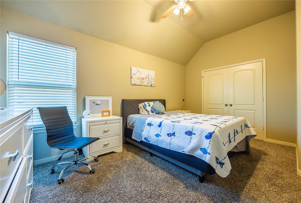 10864 Aurora Drive Waco, TX 76708 - Photo 36 of 40 a bedroom with a bed a chair and a dresser next to a window