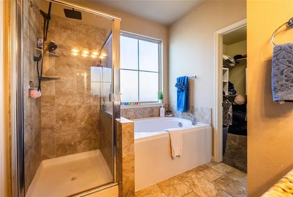 a bedroom with bed and a chandelier