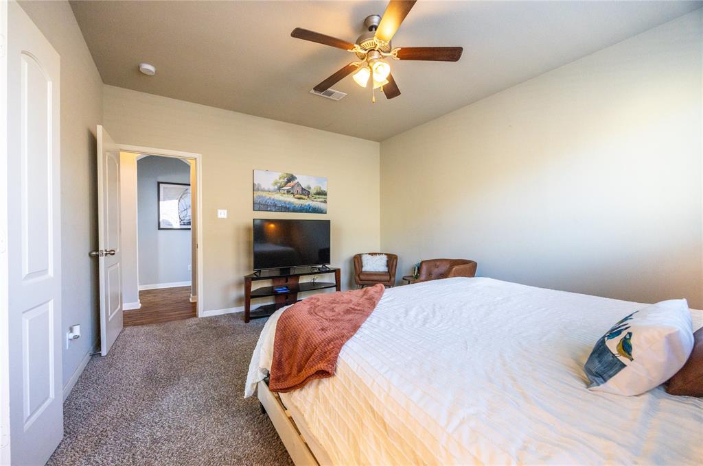 10864 Aurora Drive Waco, TX 76708 - Photo 40 of 40 a bedroom with bed and a chandelier