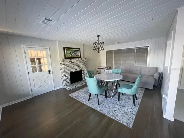 a dining room with furniture a rug and wooden floor