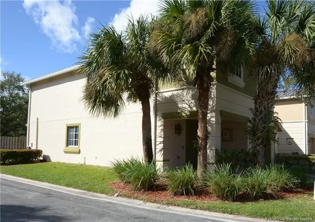 a view of a house with a palm tree
