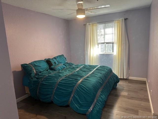 324 Southeast Bloxham Way Stuart, FL 34997 - Photo 12 of 35 a bedroom with a bed and a window