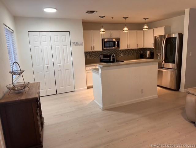 324 Southeast Bloxham Way Stuart, FL 34997 - Photo 17 of 35 a kitchen with a refrigerator and a sink